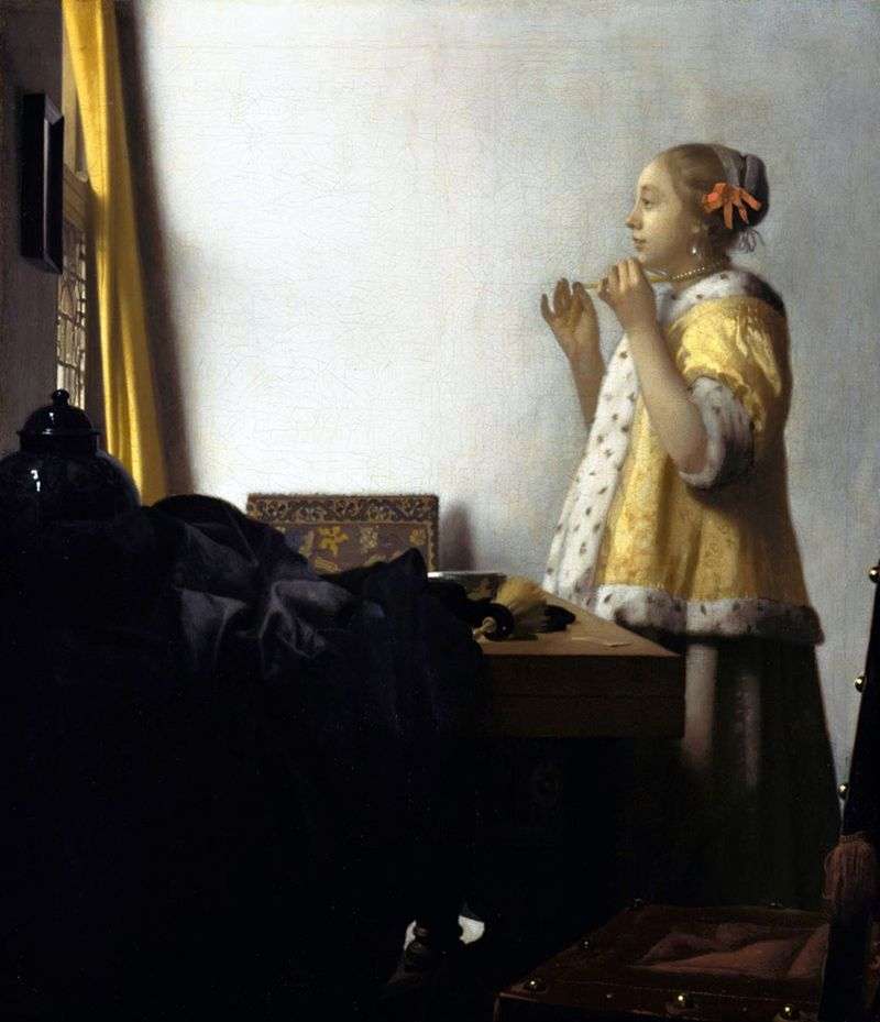 A girl trying on a necklace by Jan Vermeer